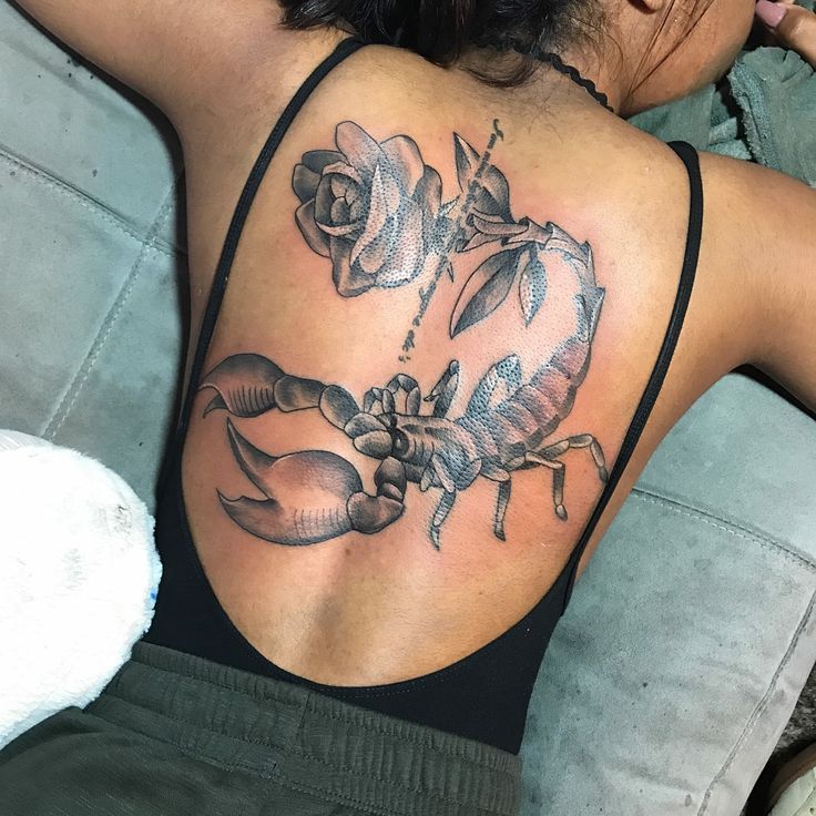 a woman with a scorpion tattoo on her back