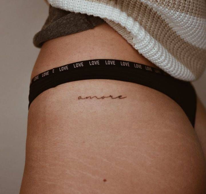 the back of a woman's thigh with a tattoo on it that says love