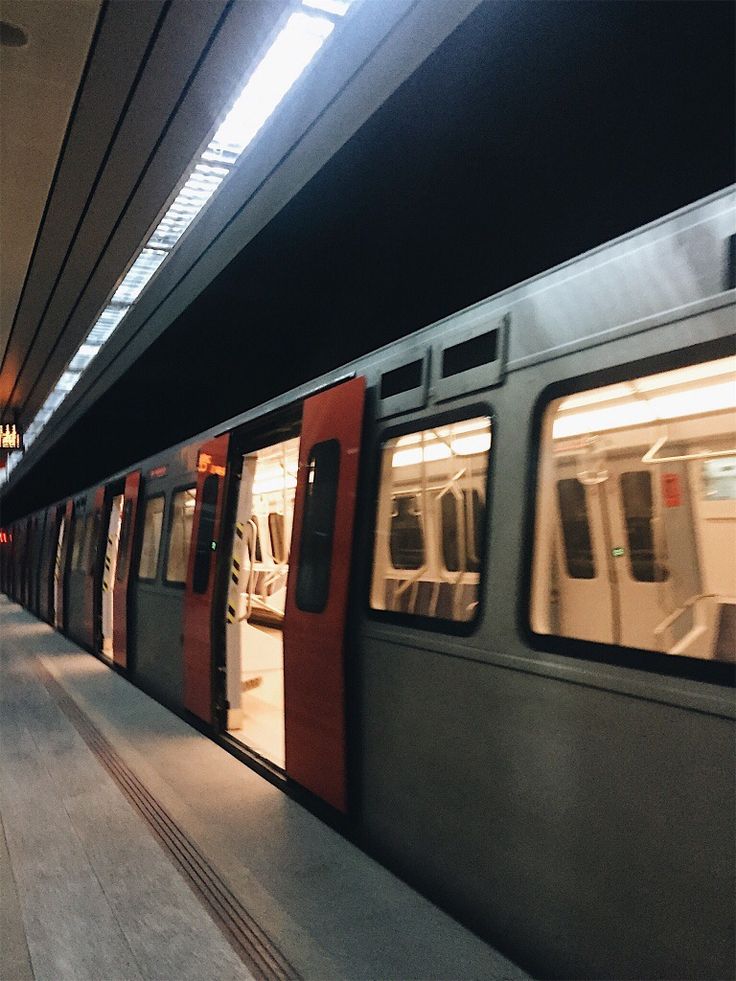 a subway train pulling into the station with its doors open