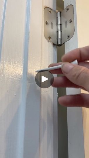 a person is opening the door with a screwdriver on their thumbnails