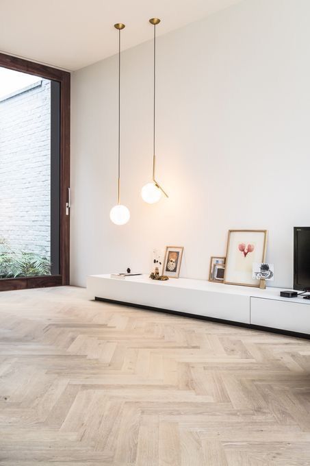 a living room filled with furniture and a flat screen tv on top of a wooden floor