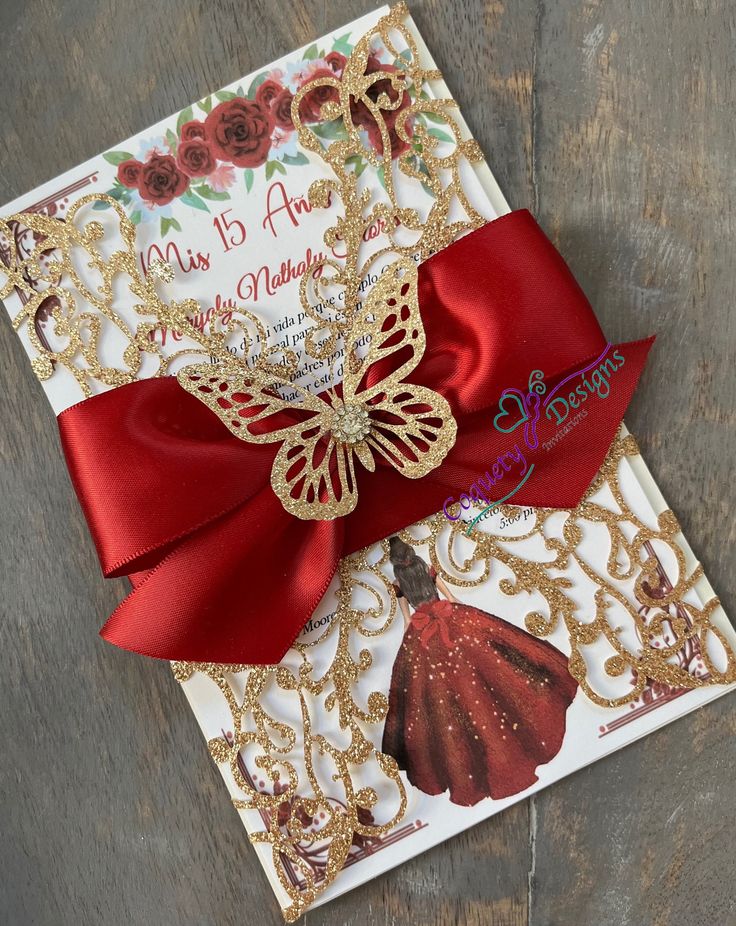 a close up of a greeting card with a red ribbon on it and a butterfly