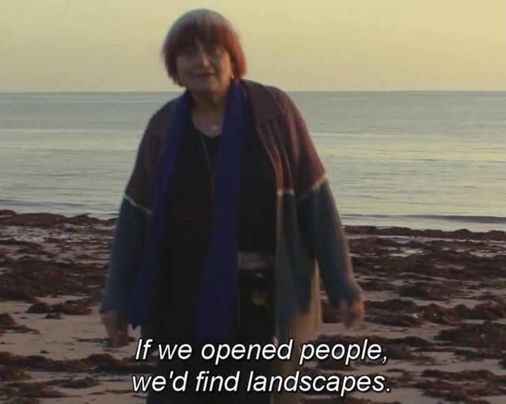 a woman standing on top of a sandy beach next to the ocean with a quote