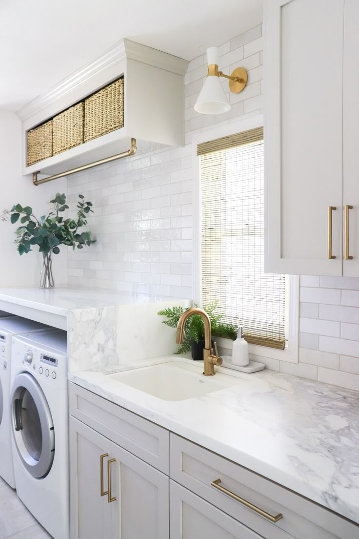 a washer and dryer in a white kitchen