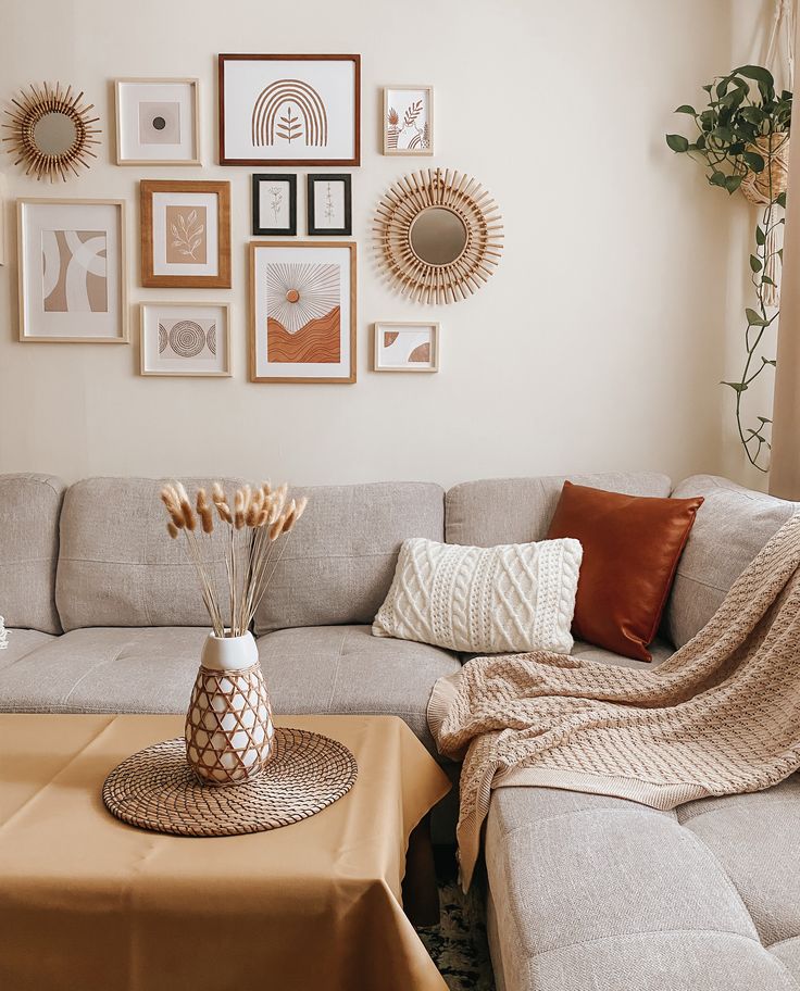 a living room filled with lots of furniture and pictures on the wall above it's coffee table