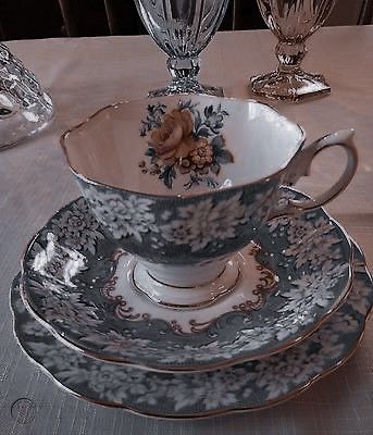 an antique tea cup and saucer on a table