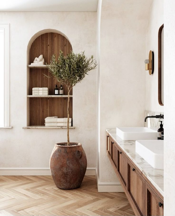 a large potted plant sitting in the middle of a bathroom