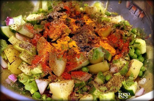 a bowl filled with chopped vegetables and seasoning