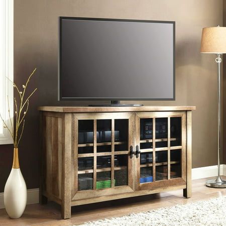 a flat screen tv sitting on top of a wooden cabinet