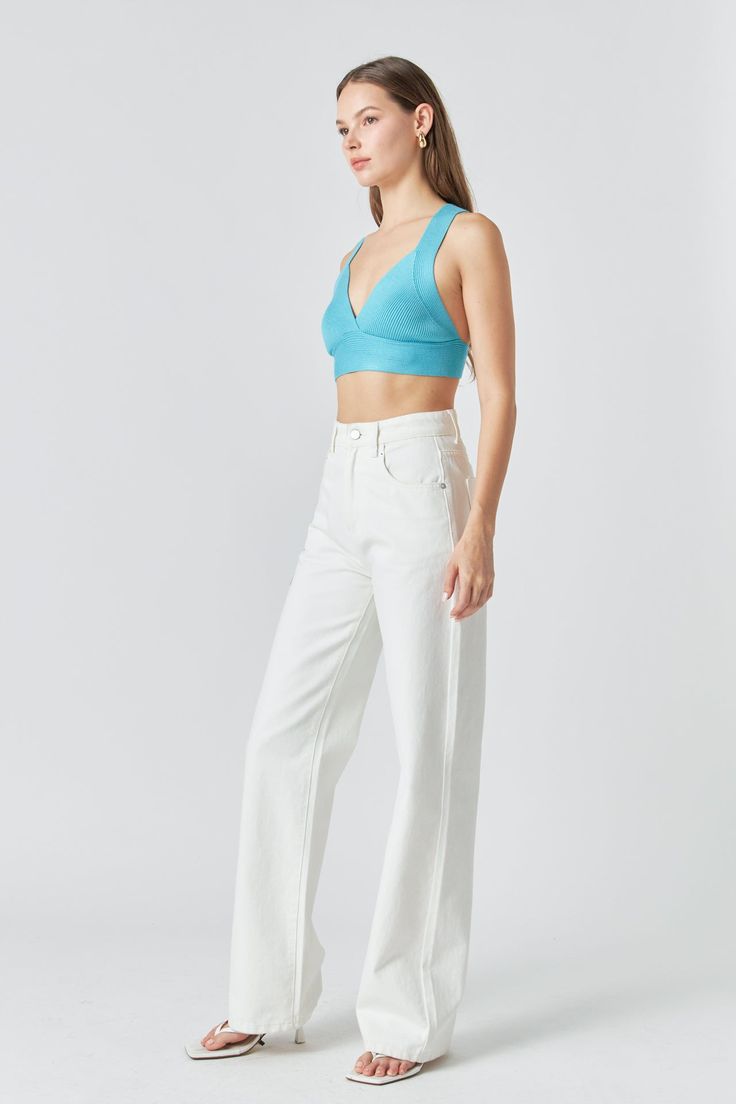 This bralette was made for flaunting. The Back Tie Elevated Knit Bralette offers just the right amount of coverage with a little extra something-something. The knit fabrication is stretchy and comfortable while the back tie detail gives this bralette a little extra flair. The thick straps provide support and the cropped length is perfect for showing off your favorite high-waisted bottoms. Knit fabrication Cropped length V-neckline Thick straps Back tie detail Hand wash cold Do not bleach Do not tumble dry Iron low Shell: 75% Viscose 25% nylon HN784T Total length: 14.75" Bust: 29.50" S AQUA: Height 5'9" / Bust 30.5" / Waist 24" / Hips 34.5" WHITE: Height 5'9" / Bust 30.5" / Waist 24" / Hips 34.5" BLACK: Height 5'9" / Bust 30.5" / Waist 24" / Hips 34.5" Stretch Triangle Top Sports Bra For Spring, Chic Seamless Bra For Spring, Chic Cropped Bra With Removable Pads, Stretch Cropped Bra For Spring, Cropped Stretch Bra For Spring, Spring Cropped Stretch Bra, Trendy White Sports Bra For Spring, Solid Color Cropped Summer Bra, Spring Sports Bra With Removable Pads