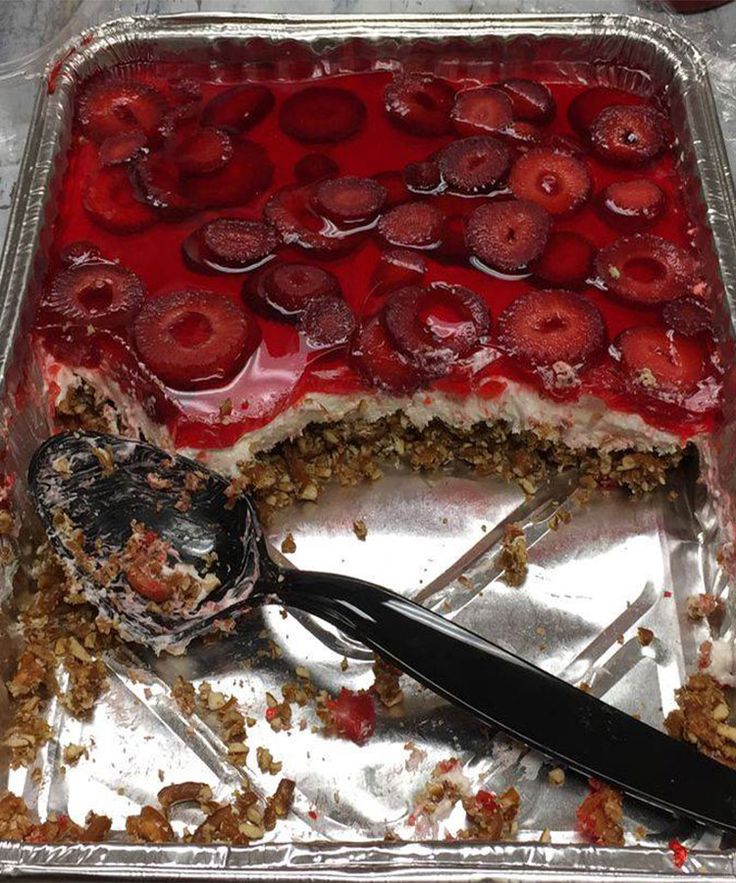 there is a cake with strawberries on it and a fork in the middle of it