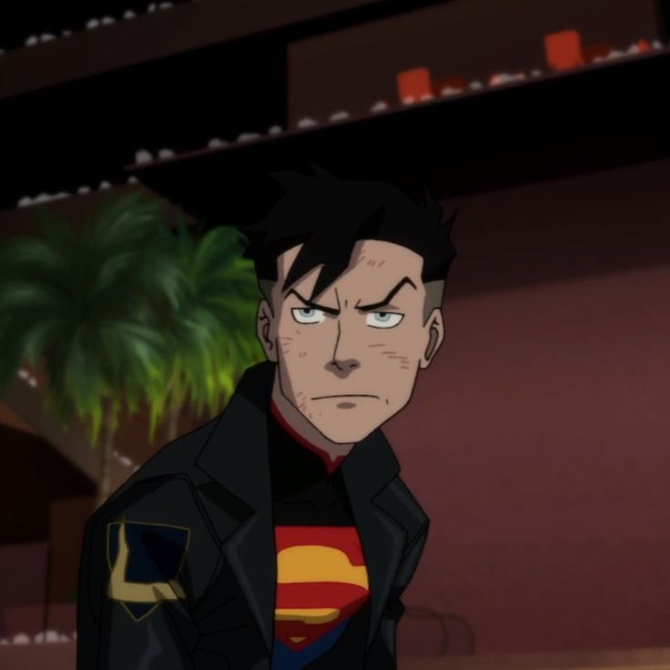 an animated image of a man wearing a superman shirt and black jacket with his eyes wide open