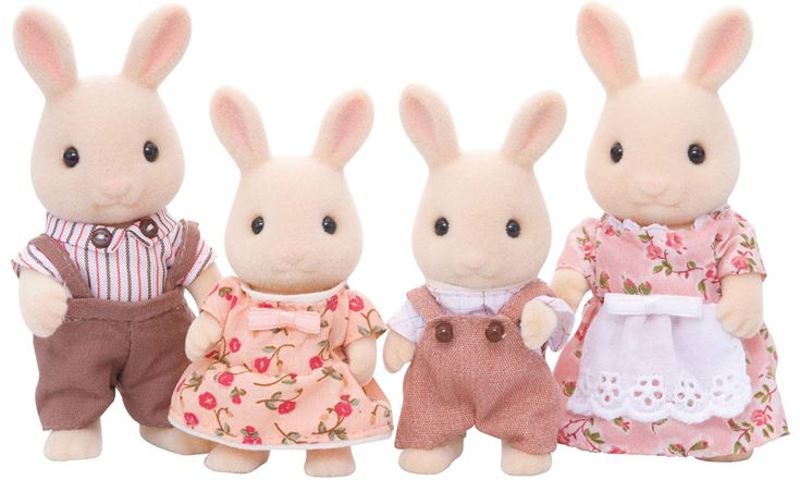 three small stuffed animals are standing next to each other in dresses and shoes, one is wearing a pink flowered dress