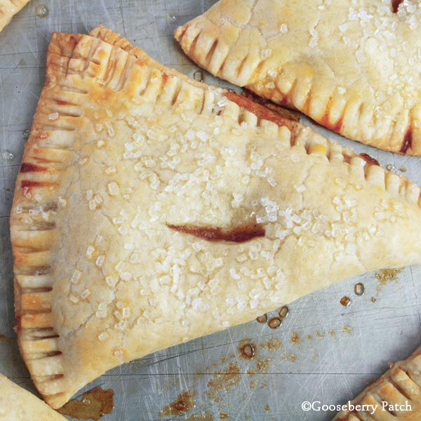 two pieces of pie sitting on top of a baking sheet