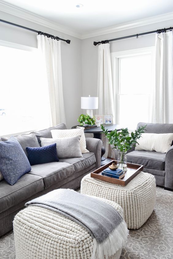 a living room with two couches and a coffee table in front of the window