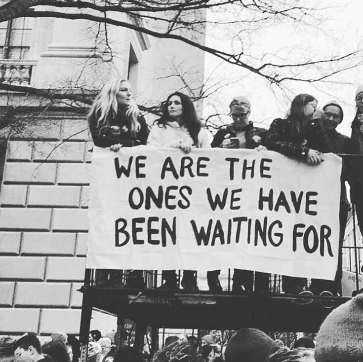 a group of people holding a sign that says we are the ones we have been waiting for