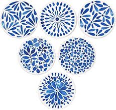 four blue and white plates with designs on them