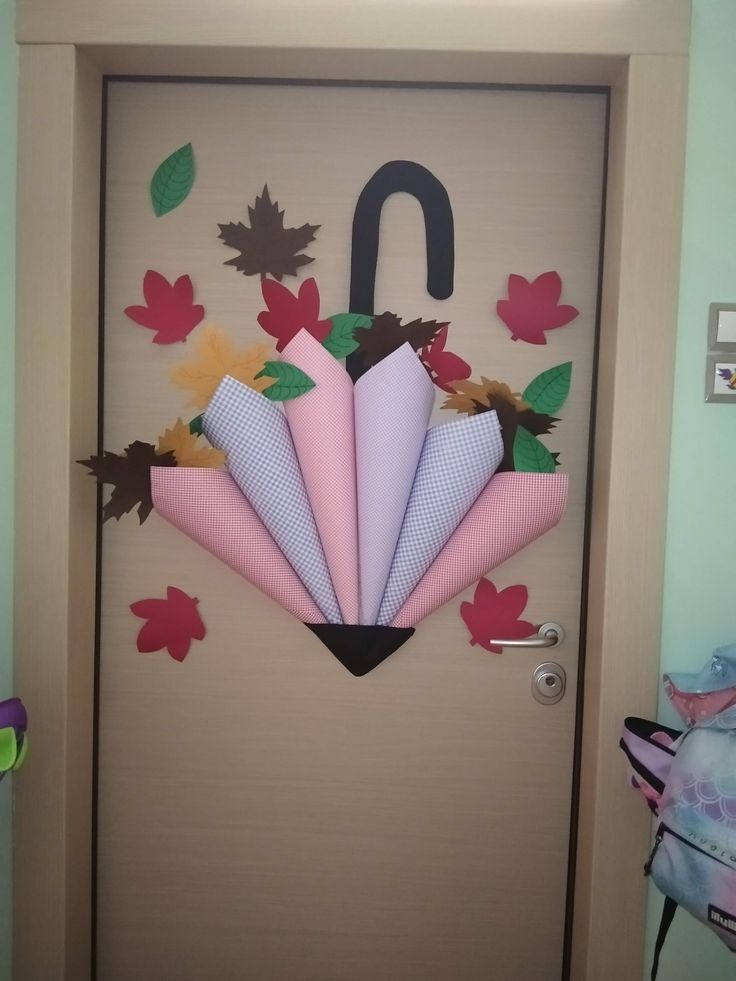 an umbrella made out of paper sitting on top of a door