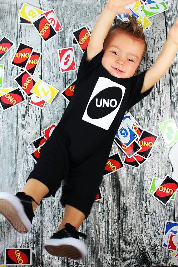 a little boy laying on top of a wooden floor covered in lots of stickers