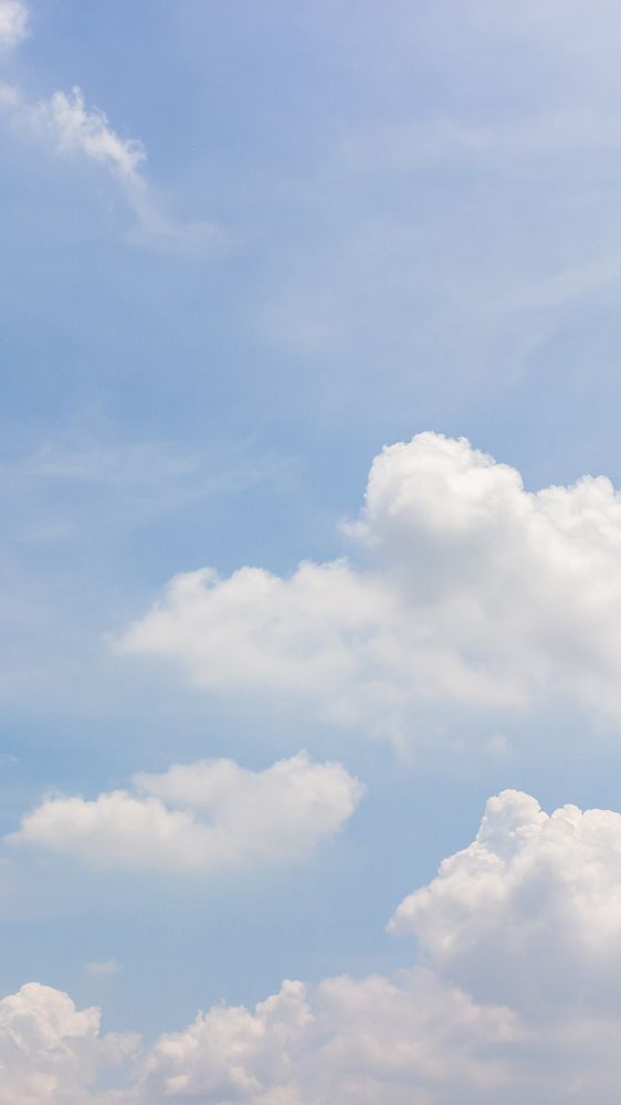 the airplane is flying high in the blue sky with white clouds behind it and an orange tail