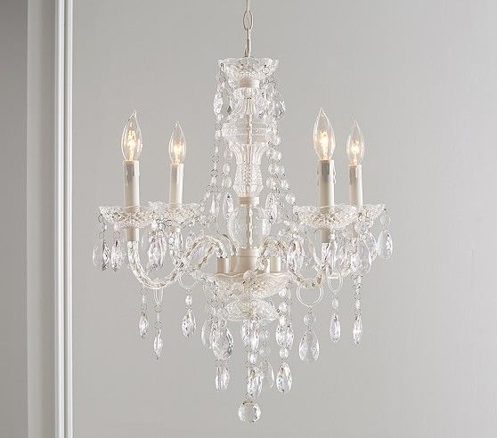 a chandelier hanging from the ceiling in a room with white walls and flooring