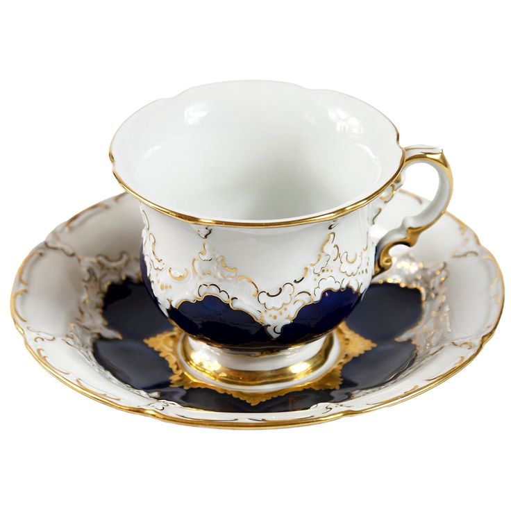 an ornate cup and saucer with gold trimmings