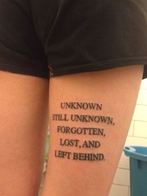 a person with a tattoo that reads unknown, still unknown, forgotten, lost, and left behind