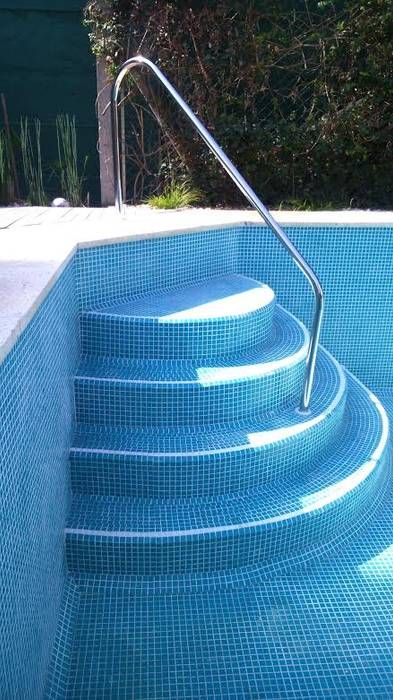 an empty swimming pool with steps leading up to it