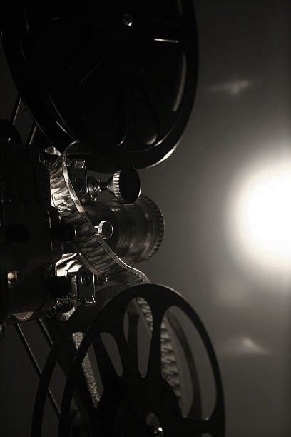 an old movie projector with the sun in the background