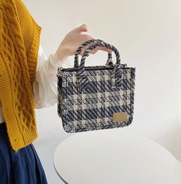 The EMES SHOP bag details a tweed plaid design for a sophisticated and classy look. Features a small blue handle and a long shoulder strap so that it can be worn in multiple styles.MATERIAL:100% BrushedPoly Blend| 100% Vegan Leather TrimMEASUREMENTS:H" X W"X D" 23cm X 17.5cm X 9cm 9.1in X 6.9in X 3.5in Blue Bag With Adjustable Strap For Fall, Blue Bags With Adjustable Strap For Fall, Blue Rectangular Bag For Fall, Rectangular Blue Bag For Fall, Trendy Blue Bags For Fall, Blue Shoulder Bag For Daily Use In Fall, Plaid Rectangular Bag For Fall, Tweed Top Handle Shoulder Bag For Everyday, Everyday Tweed Top Handle Shoulder Bag