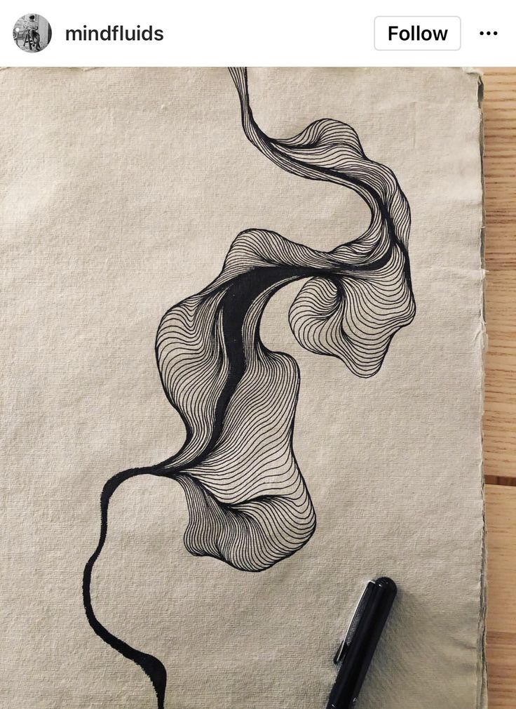 a piece of paper with a drawing on it next to a pen and some ink