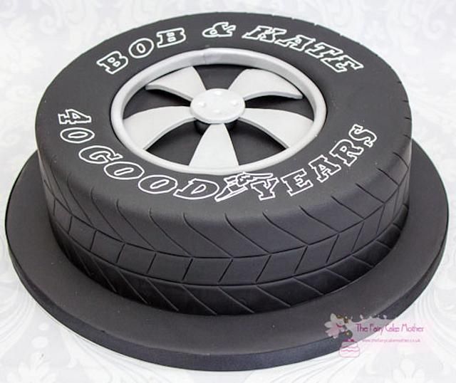 a cake that is on top of a black and white plate with the words goodyear written on it