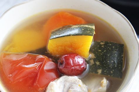 a white bowl filled with soup and vegetables