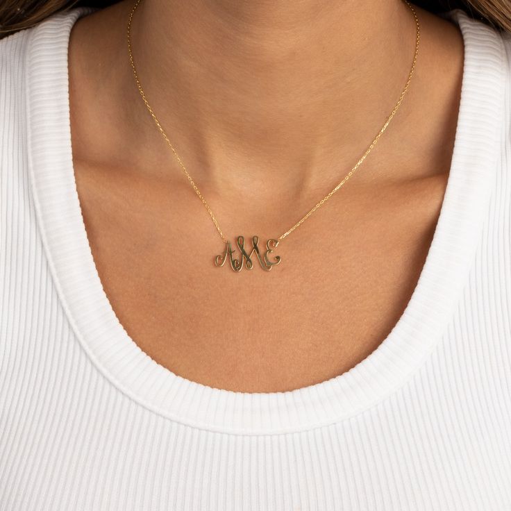 Indulge in personalized elegance with the Adina Eden Solid Script Monogram Pendant Necklace. Crafted from luxurious sterling silver and adorned with a radiant gold plating, this necklace exudes sophistication. Featuring space for three initials, it offers a bespoke touch to your ensemble. With a length of 15" and a 2" extender, it ensures a comfortable and adjustable fit. Elevate your style with this exquisite monogram pendant necklace. Product Details Made from Sterling Silver Gold Plated 3 Ini Elegant Gold Initial Necklace With Name Detail, Elegant Necklaces With Initials For Anniversary, Elegant 14k Gold Monogram Charm Necklace, Elegant Engraved Nameplate Initial Necklace, Elegant Nameplate Monogram Necklace, Elegant Yellow Gold Initials Necklace, Elegant Initial Necklace With Round Pendant, Elegant Initial Pendant Necklace, Elegant Personalized Initial Pendant Necklaces