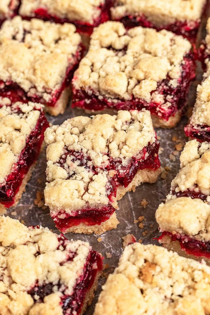 several pieces of dessert sitting on top of a metal pan covered in crumbs