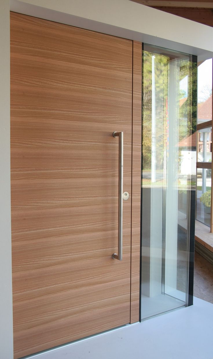 a modern wooden door with glass panels on the outside