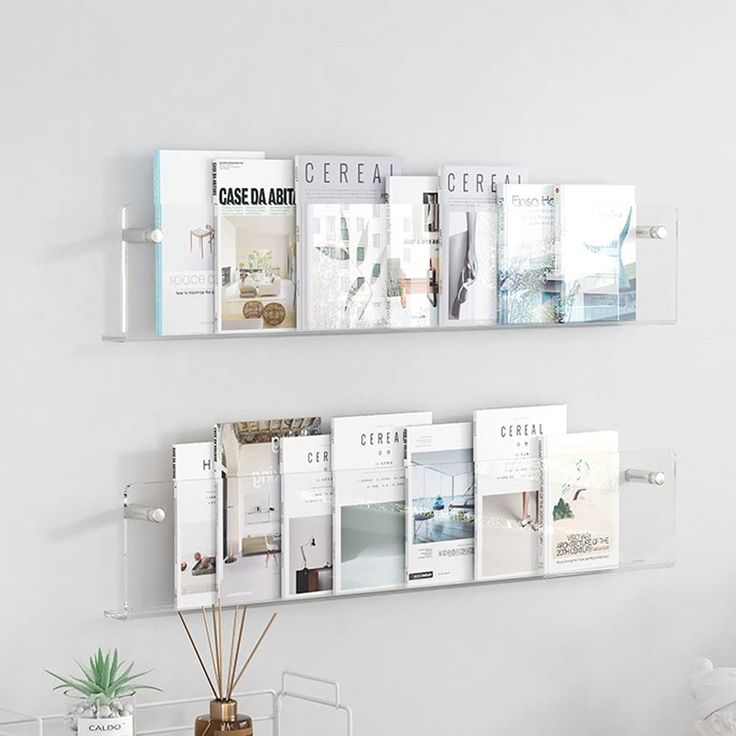 there are two shelves on the wall with magazines