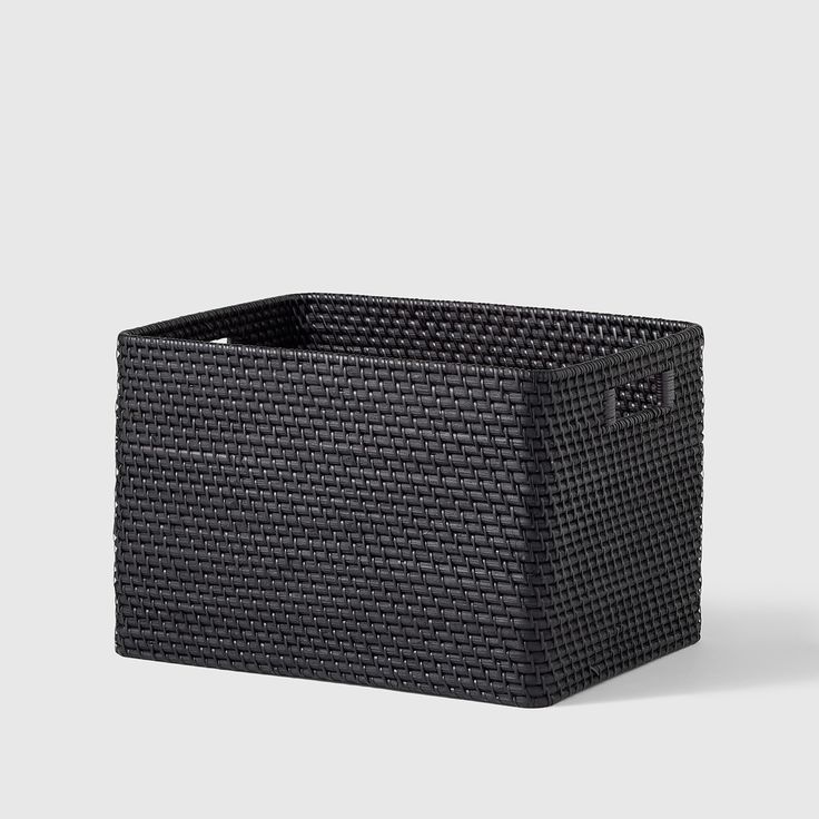 a black basket sitting on top of a table