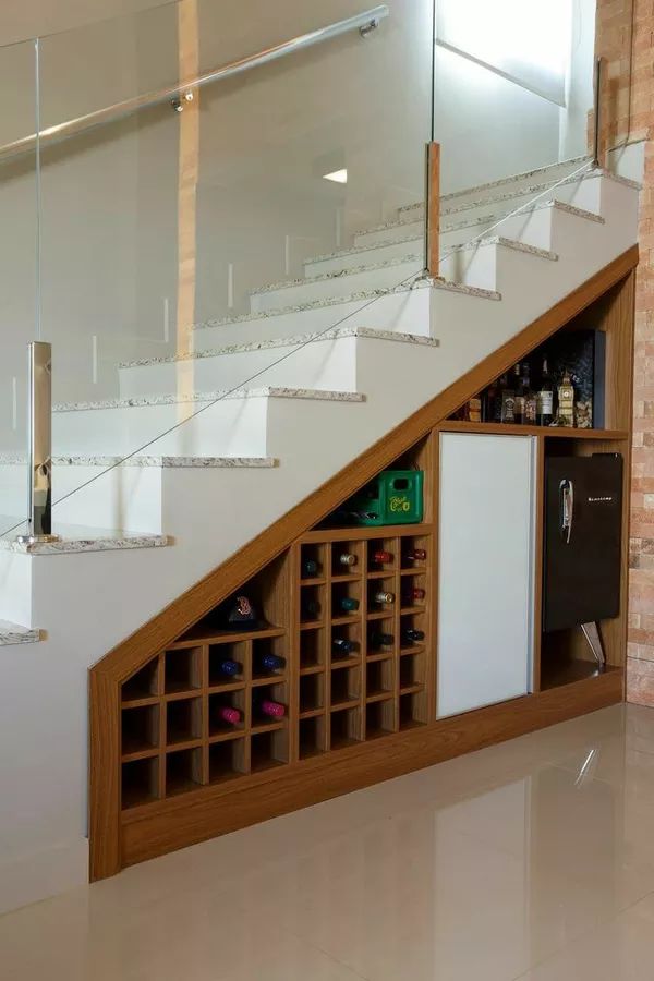 there is a wine rack under the stairs