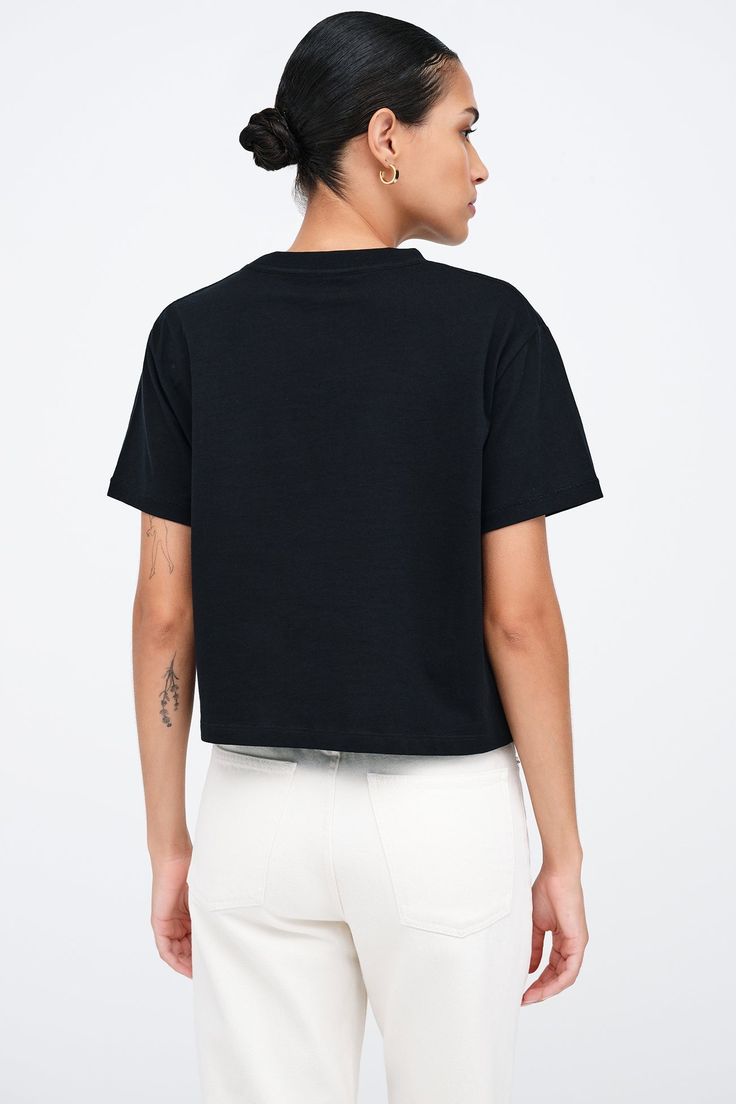 Our Rya Tee is for those who expect their basics to go above and beyond. Fashioned from French organic cotton jersey, she offers unrivaled softness and breathability in a cropped, oversized cut. With short sleeves and a rib-knit crew neck for visual interest, this classic tee works solo or as a base to create countless unique looks.[SPLIT] Astrid, in black, is 5'9" (175 cm) tall, wearing size XS. Rocio, in white, is 5'9.5" (175 cm) tall, wearing size XS. Total length is approximately 20" (51 cm) Boxy Tee, Social Impact, Work Week, Tee Outfit, The A Team, Above And Beyond, Black Tee, French Terry, Rib Knit