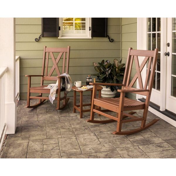 two wooden rocking chairs sitting on top of a porch next to a potted plant