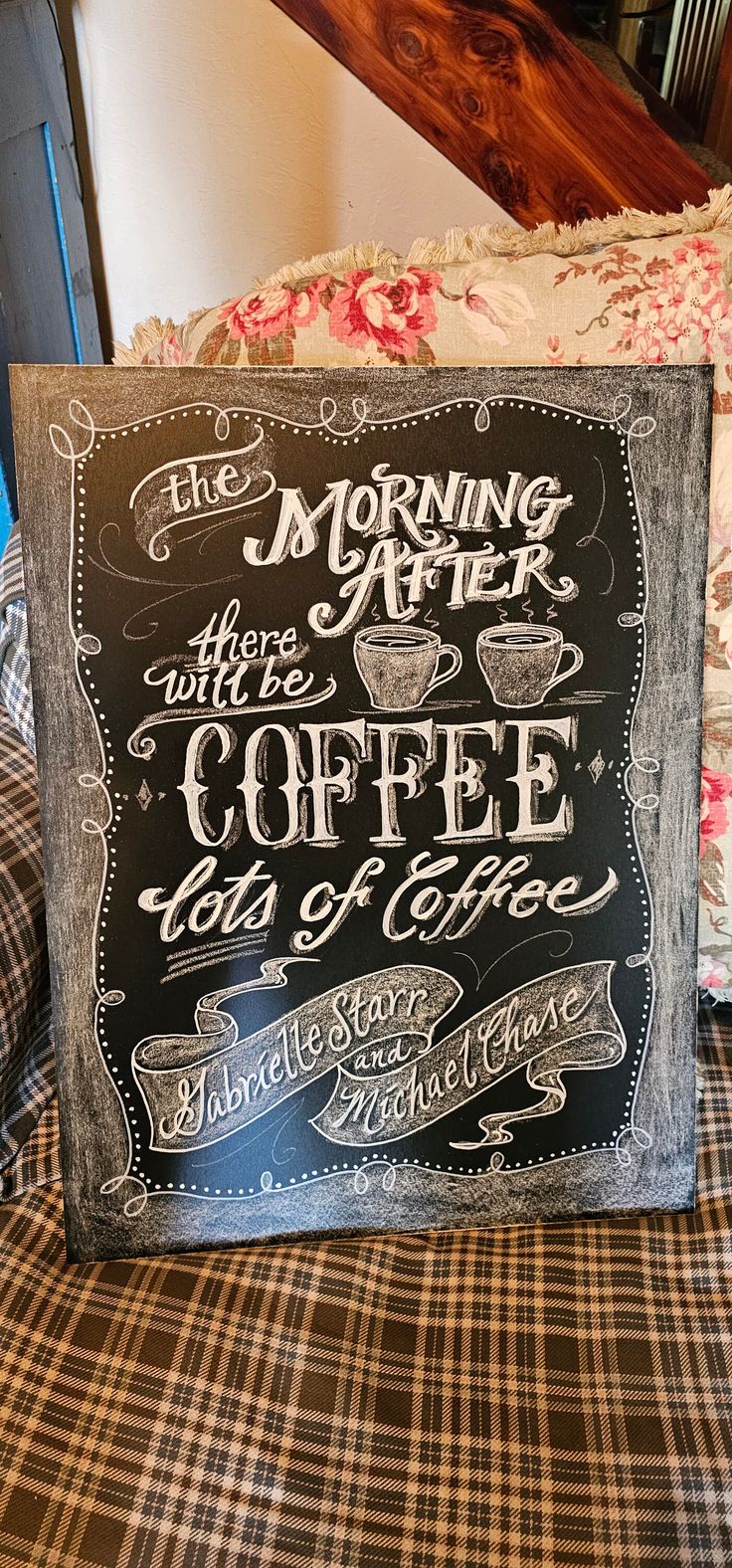 a chalkboard sign sitting on top of a bed