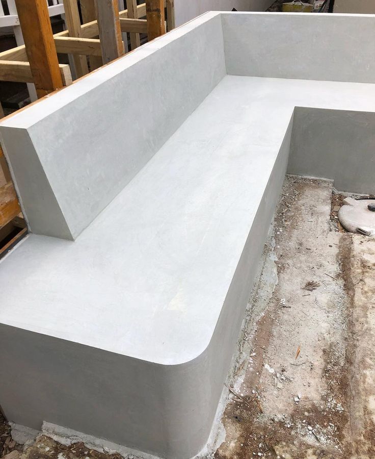 a concrete bench sitting on top of a hard wood floor