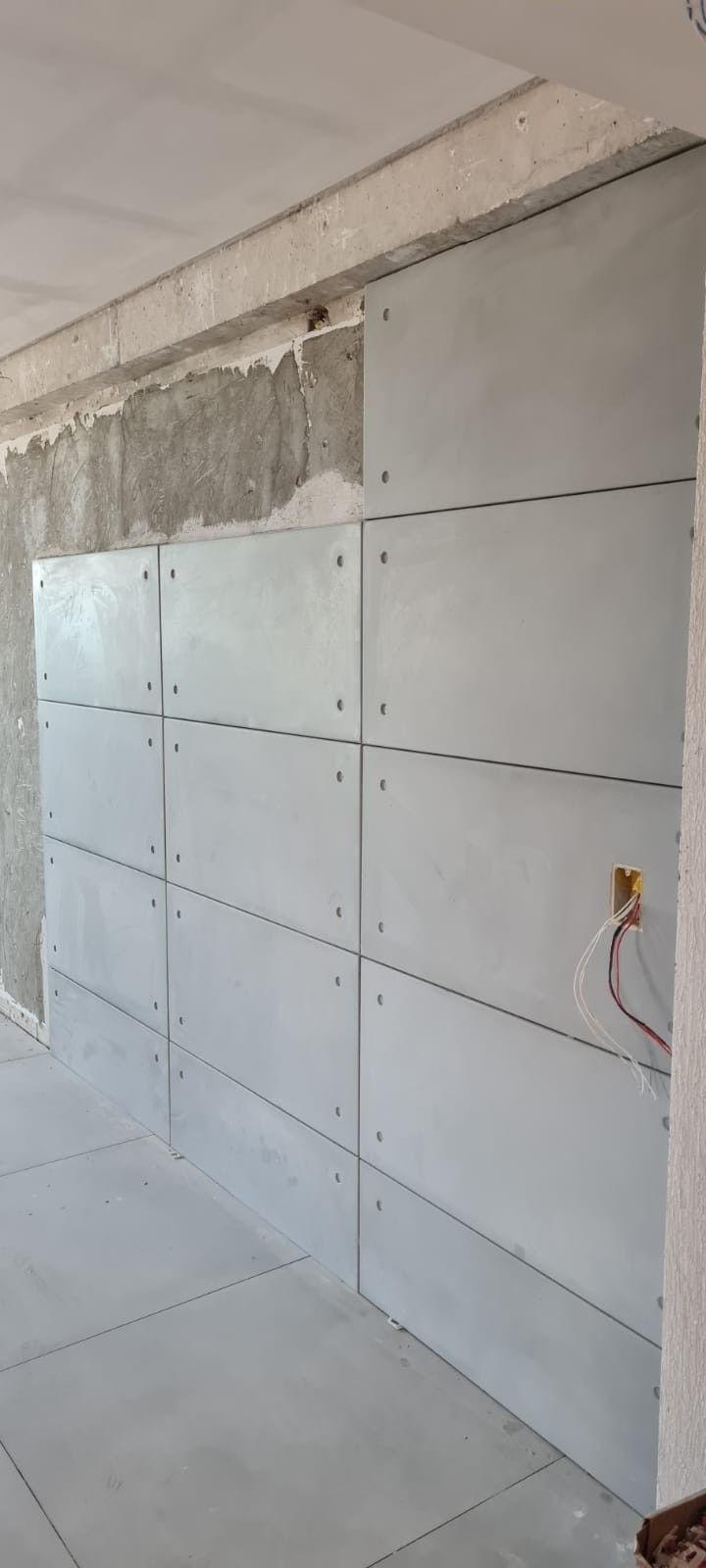 an unfinished room with concrete walls and electrical wires attached to the side of the wall