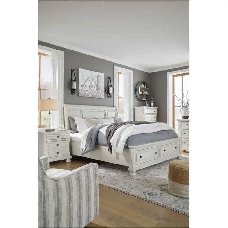 a bedroom with gray walls and white furniture