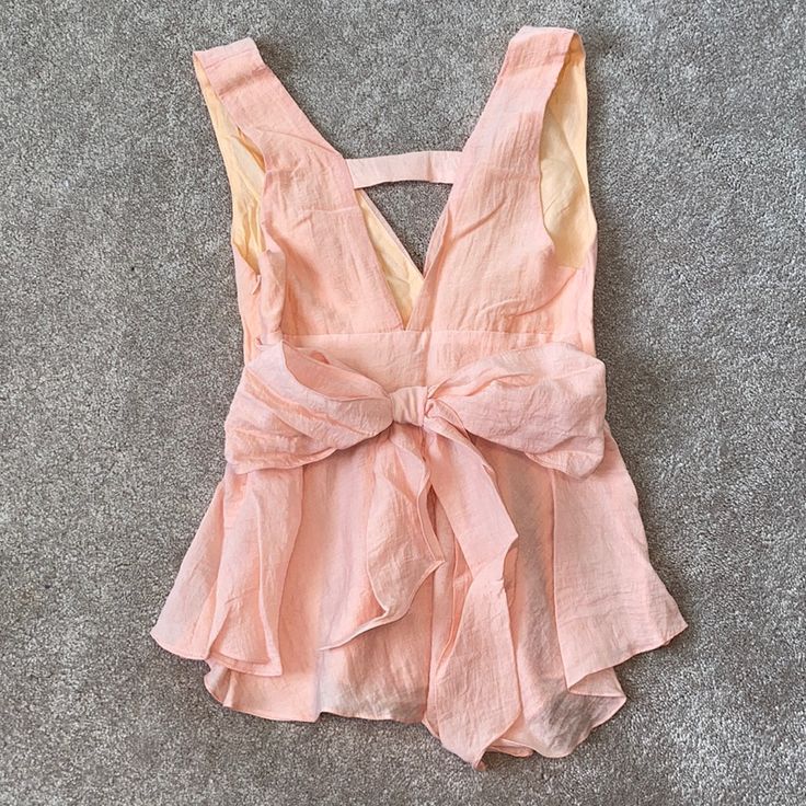 Can Be Tied In The Back Or Front. Never Worn Spring Beach Tops With Tied Detail, Summer Party Tops With Bow Tie Back, Summer Vacation Tops With Tied Details, Chic Tied Blouse For Summer, Chic Summer Tied Blouse, Tied Tops For Spring Vacation, Spring Vacation Tied Top, Chic Pink Top With Tie Back, Chic Pink Tie Back Top