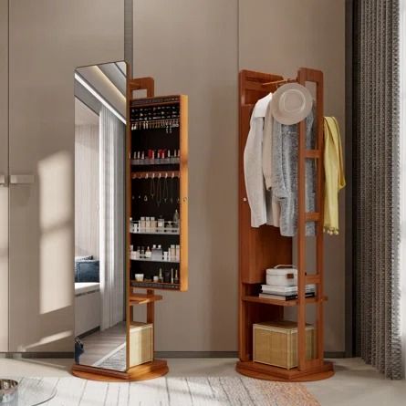 a mirror and shelf in a room with clothes hanging on the rack next to it