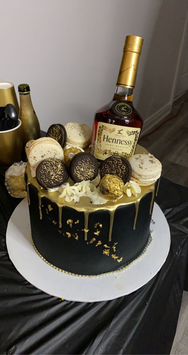 there is a cake with chocolates and liquor on it