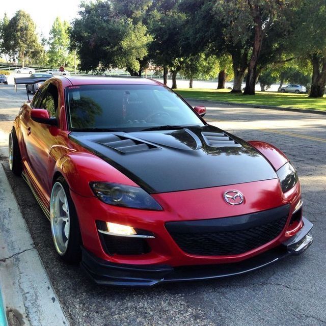 a red sports car parked on the side of the road