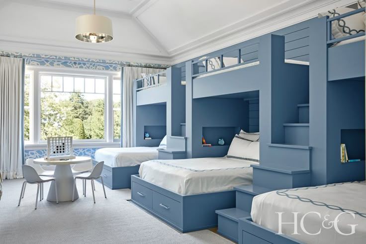 a bedroom with blue walls and bunk beds in the middle, along with white carpeted flooring